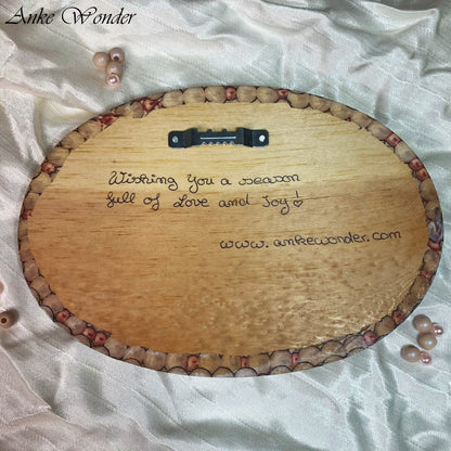 Backside of Christmas Handmade wooden wall decor with the words 'Wishing you a season full of Love and Joy' by Anke Wonder.