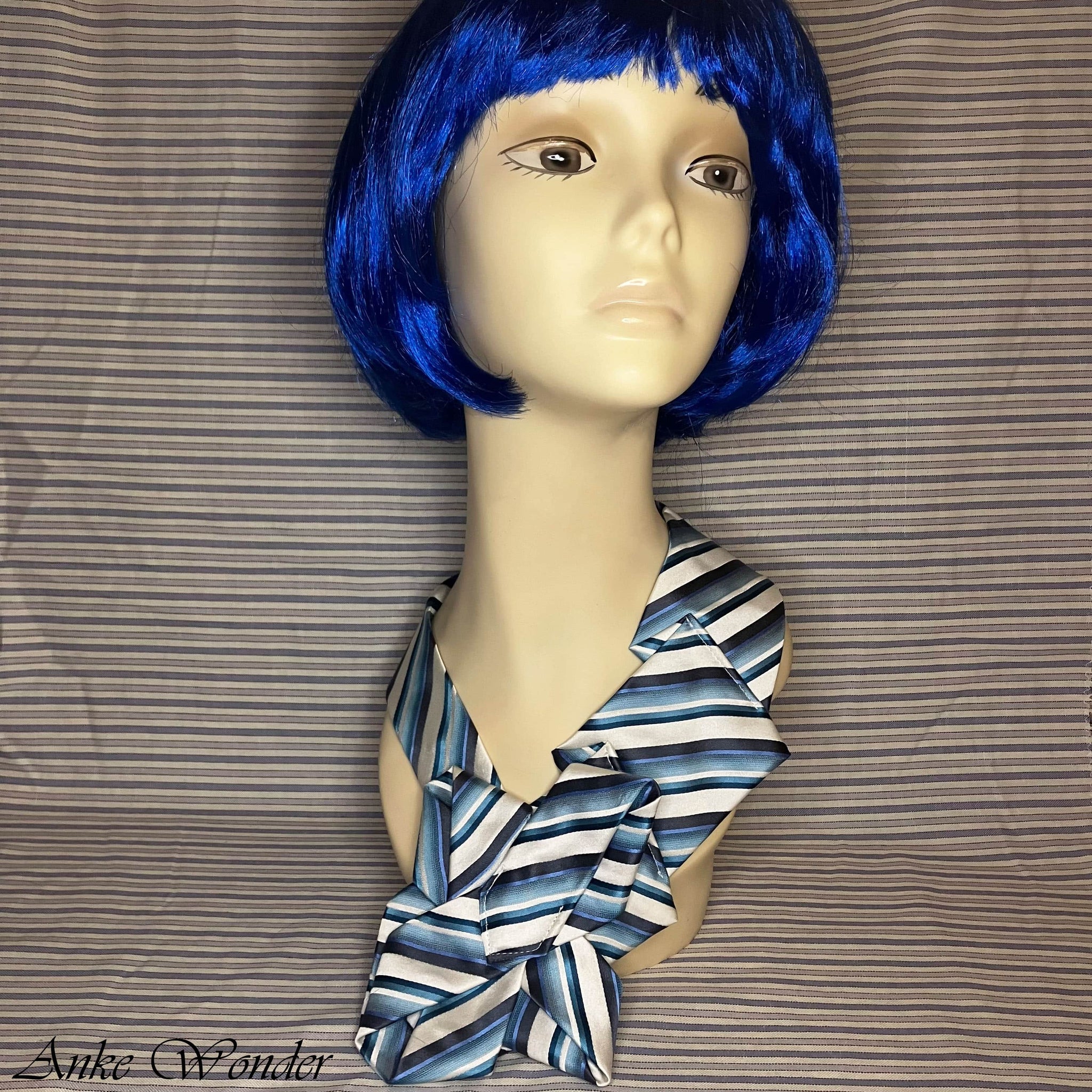 Necktie on mannequin - front view, blue and white striped design.