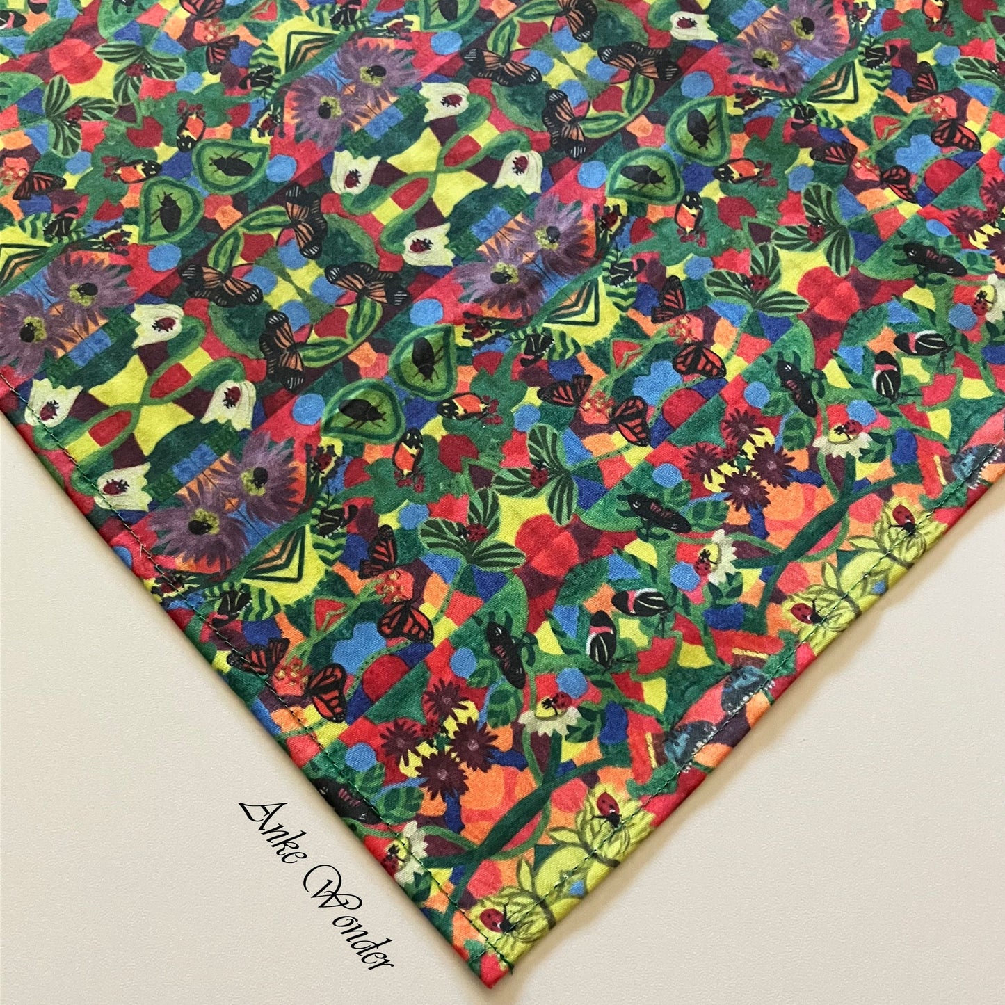 Close-up of one corner of the eco-friendly tablecloth, showing high-quality stitching and detailed floral artwork by Anke Wonder.