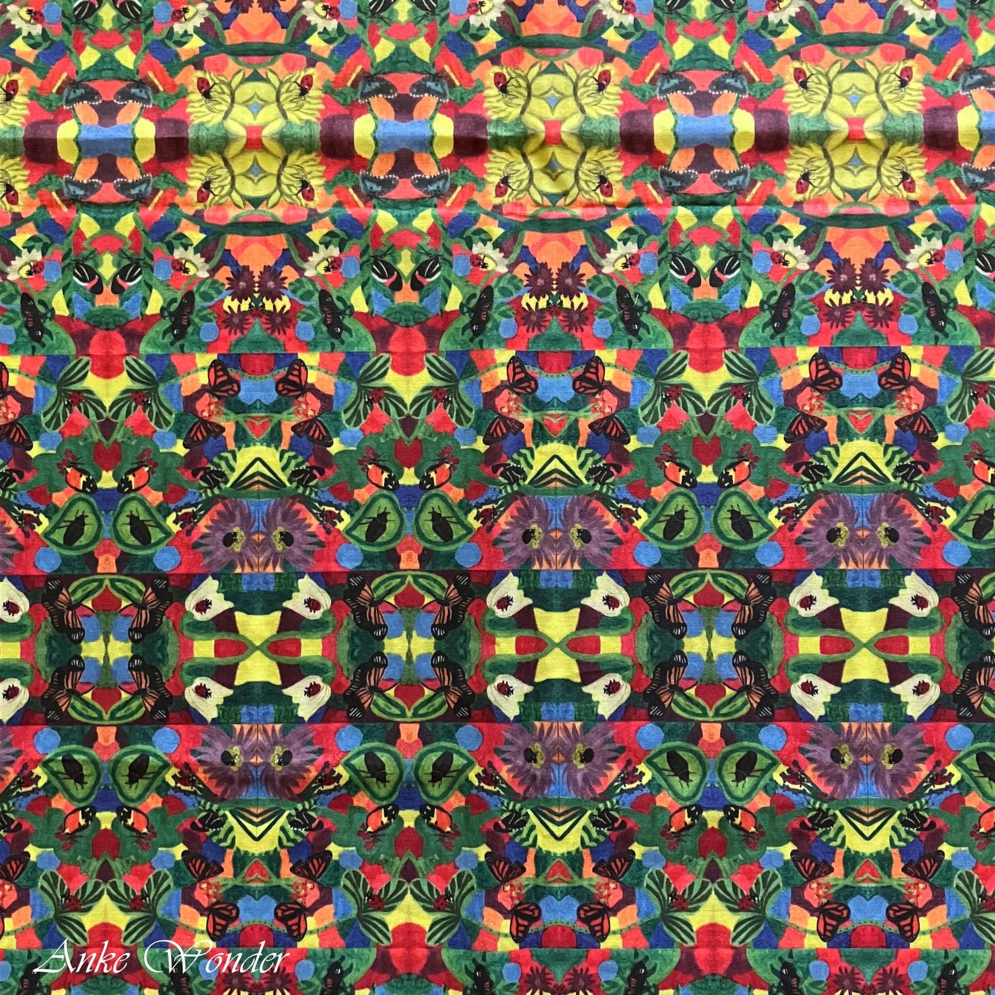 A detailed view of the colorful floral pattern with butterflies and ladybugs, digitally printed on organic cotton sateen fabric.