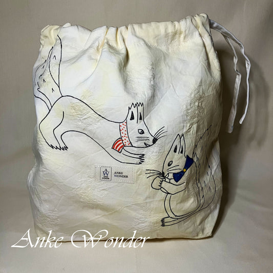 Drawstring bag with cartoon squirrel design and 'Anke Wonder' branding on a beige background