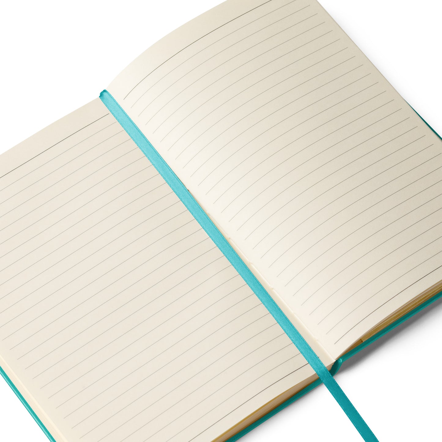 Close-up of the Lucky Paws notebook showing cream-colored lined pages with a matching green ribbon for easy marking.