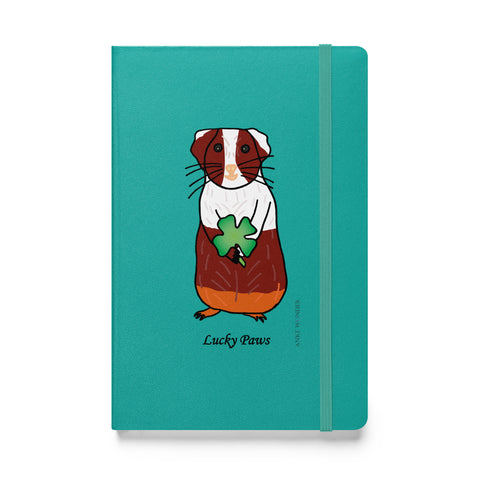 Front view of the Lucky Paws Guinea Pig Notebook featuring a cute brown and white guinea pig with a shamrock on a white background.