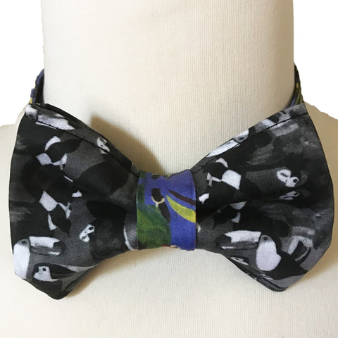 Men's organic cotton bow tie with a black and white bird pattern, displayed on a mannequin, front view.