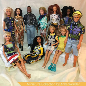 Barbie and Ken dolls wearing handmade outfits.