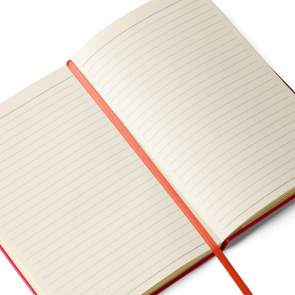 Open view of a red notebook with a bunny holding a rose on the cover, displaying cream-colored lined pages and a red ribbon page marker.