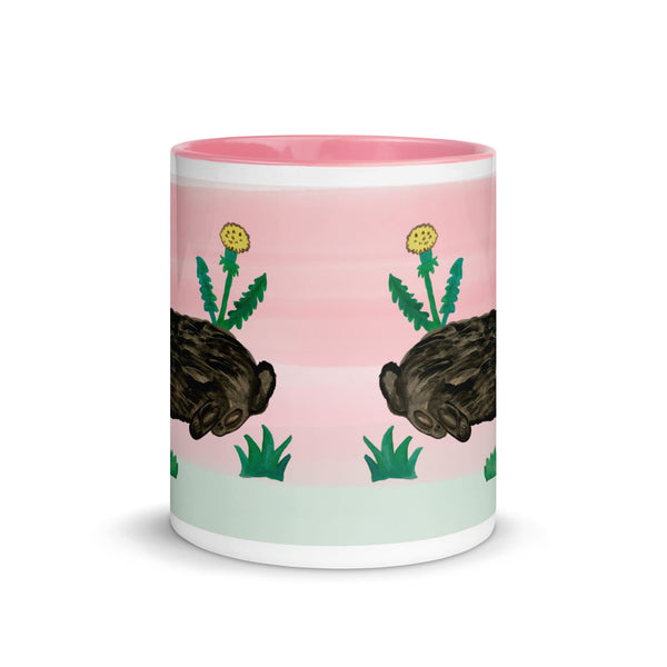 A white ceramic mug with a pink rim and handle, showcasing a charming bunny enjoying a sunny day.