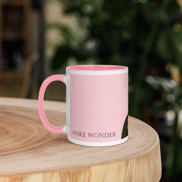 Left side view of pink ceramic mug with Anke Wonder label and handle, designed with a crowned guinea pig for a royal touch.