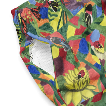 Close-up of mesh side pocket of men’s swim trunks with colorful floral insect print.