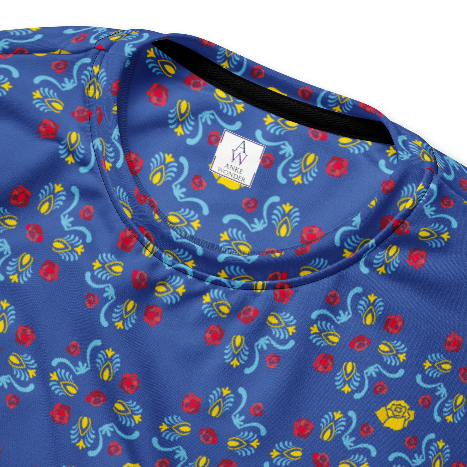 A close-up inside photo of recycled polyester sweatshirt with blue, yellow and red floral print and the Anke Wonder logo.