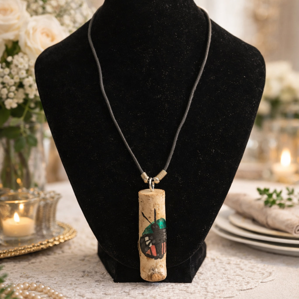Necklace with a wood pendant on a black velvet stand, with a blurred decorative background.