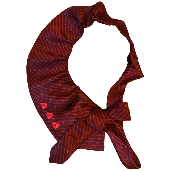 Front view of a red women's necktie with a pleated bow and heart details in front of white background.