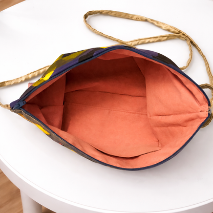 Colorful bag with a gold handle on a white surface