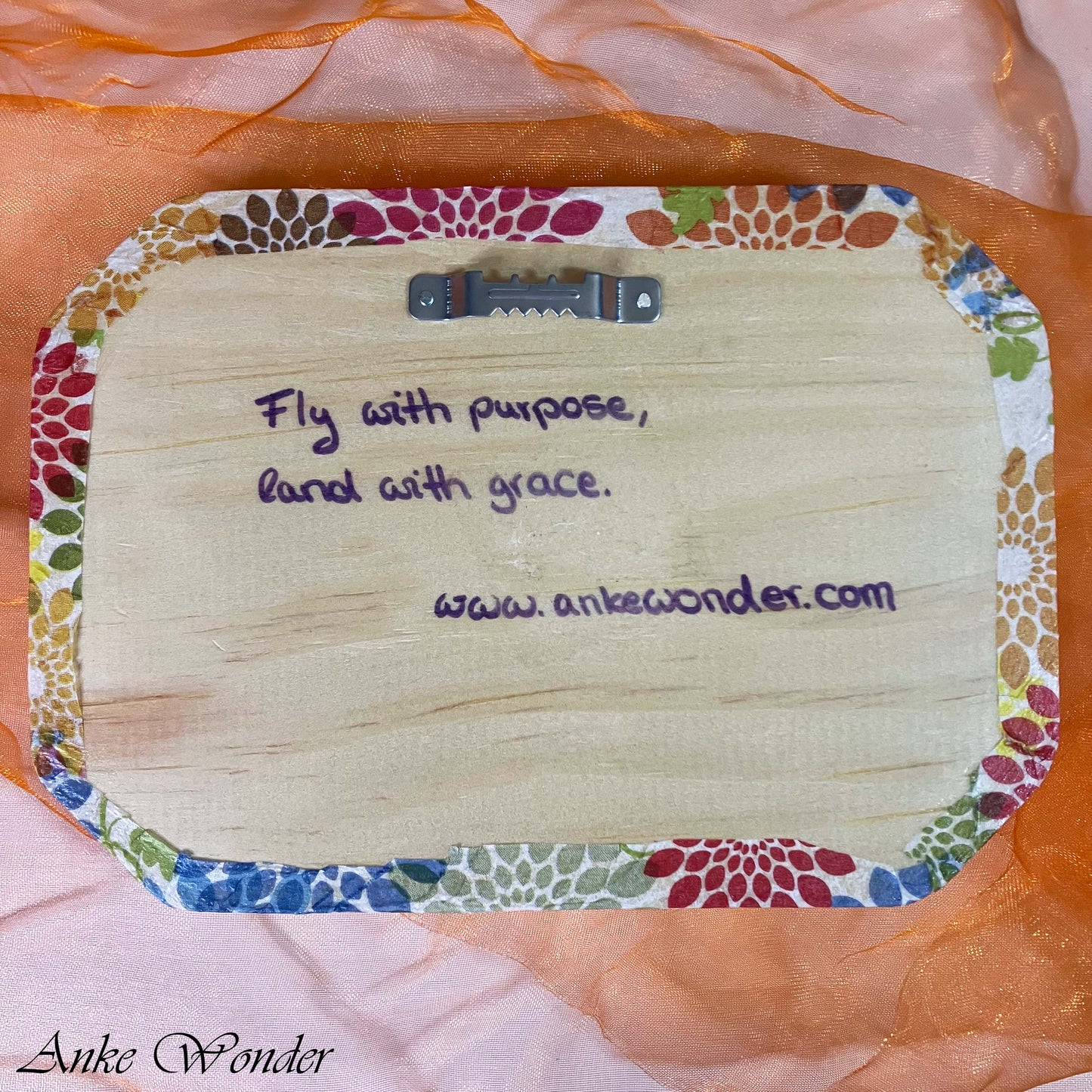 Back view of wooden wall art with mounting hooks for easy hanging, showcasing the backside of the decoupage plaque.