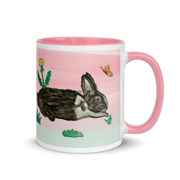 Right Side of a hand-painted ceramic mug with a bunny, dandelion, and butterfly design, perfect for spring - designed by Anke Wonder.