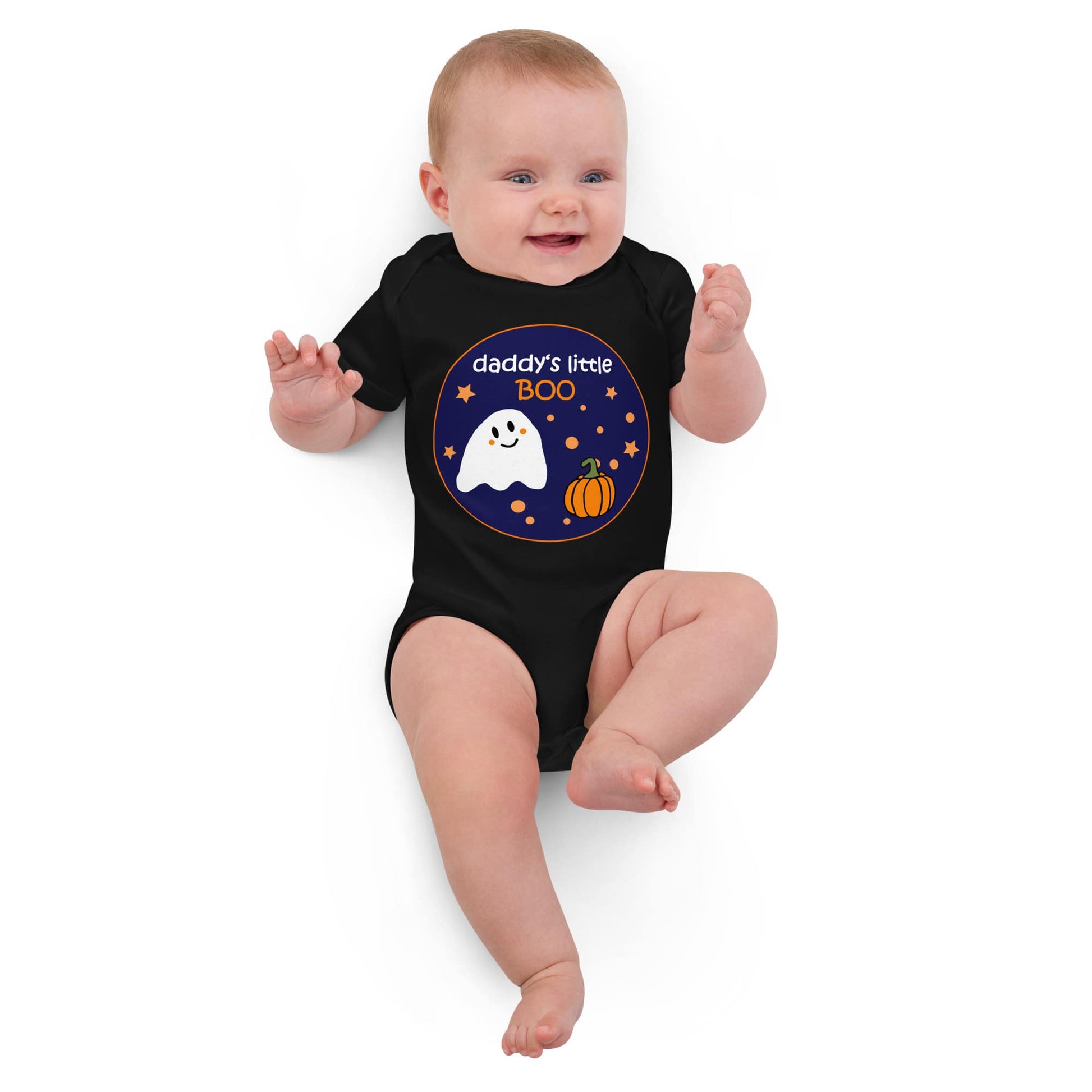 White baby girl lying down in a black organic cotton bodysuit with Halloween-themed "Daddy's Little BOO" print.