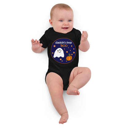 White baby girl lying down in a black organic cotton bodysuit with Halloween-themed "Daddy's Little BOO" print.