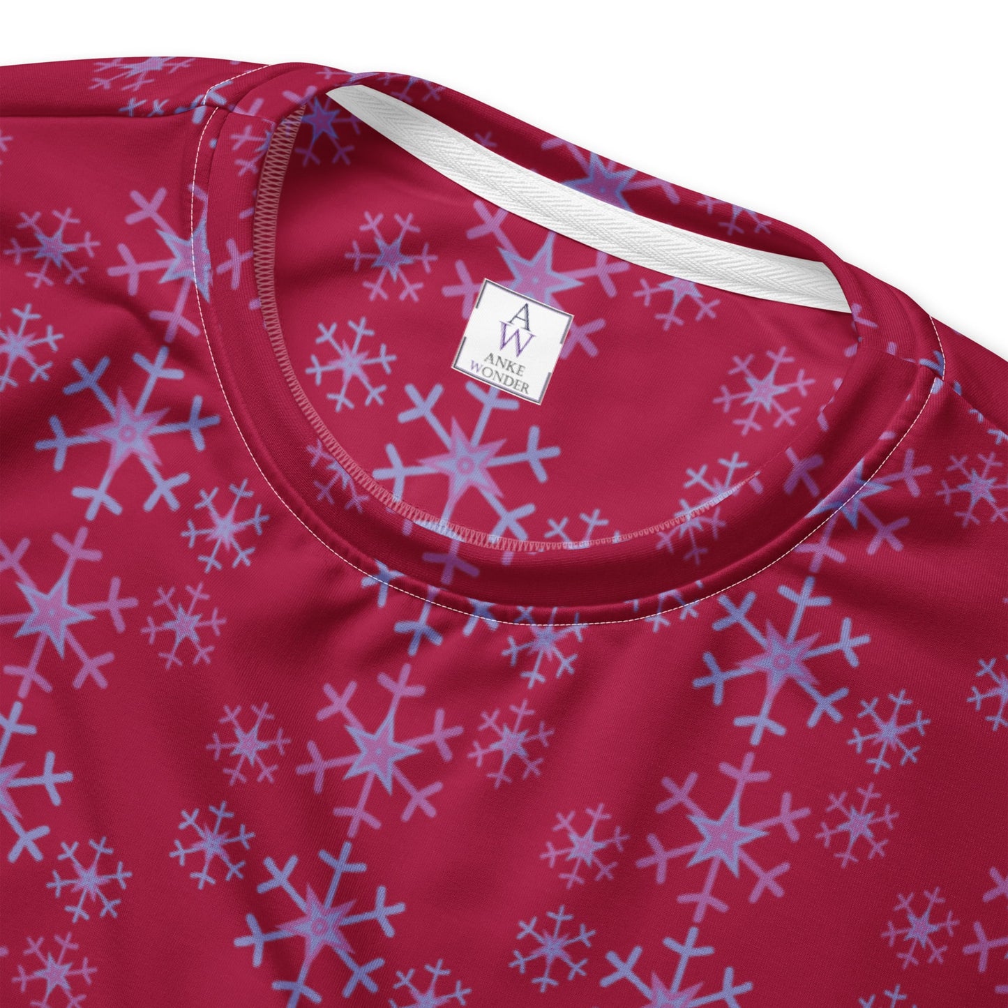 Detailed close-up of the inside Anke Wonder label of the Festive Snowflake Women's Sweatshirt.