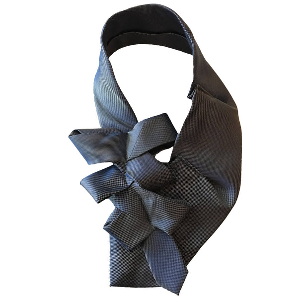 Front view of a blue women's necktie with bow details in front of white background.