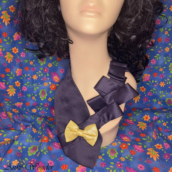 Closeup of a handmade blue silk necktie with a yellow bow on a mannequin, highlighting the pleated design.