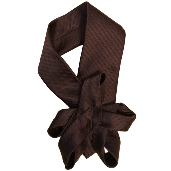 Handmade brown necktie with a floral design displayed flat on a table, highlighting the front details.