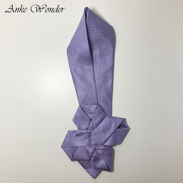 Handmade purple silk necktie with floral design, laid flat on a table with the front side displayed. Upcycled from a men’s tie.