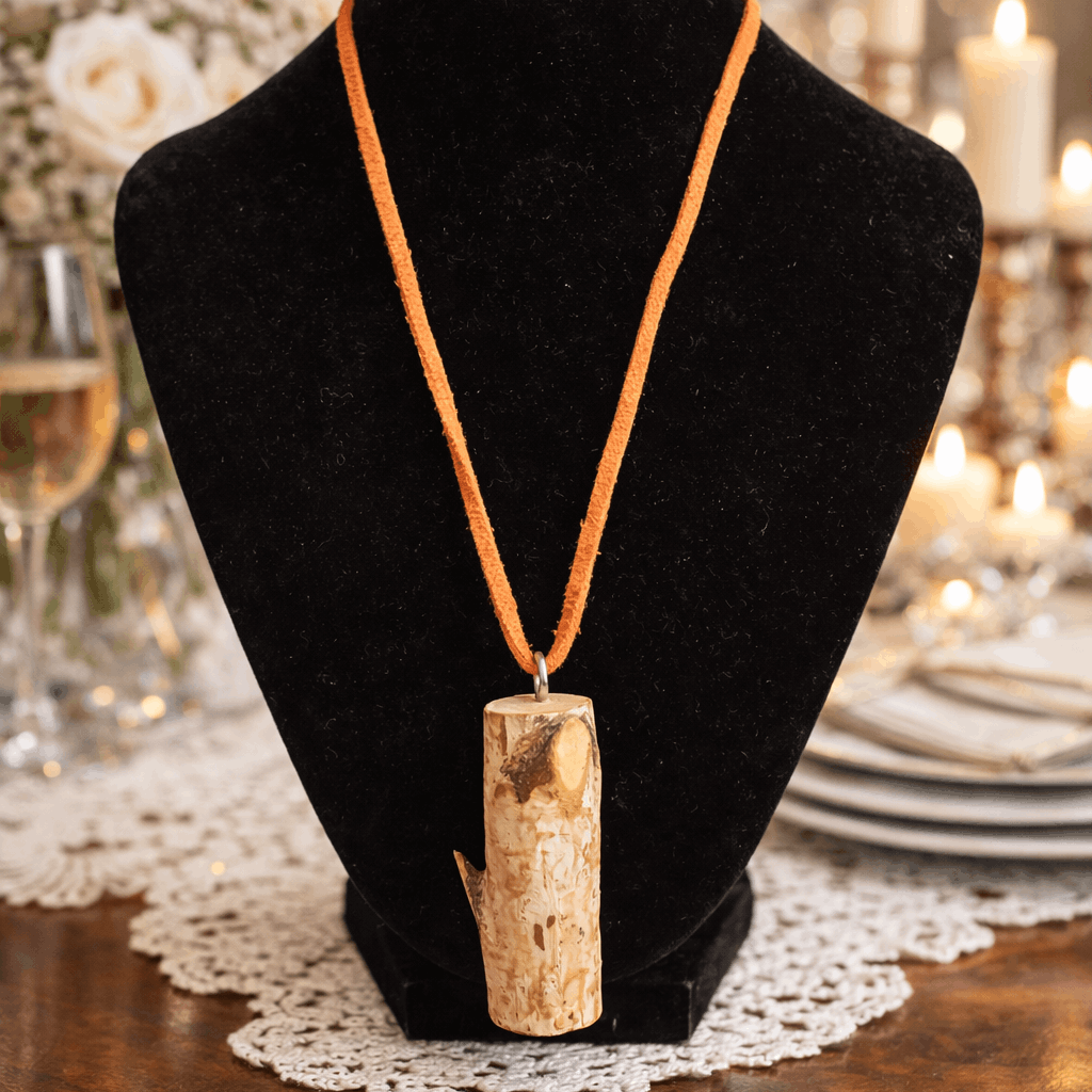 Necklace with a wooden pendant on a black bust in a festive setting