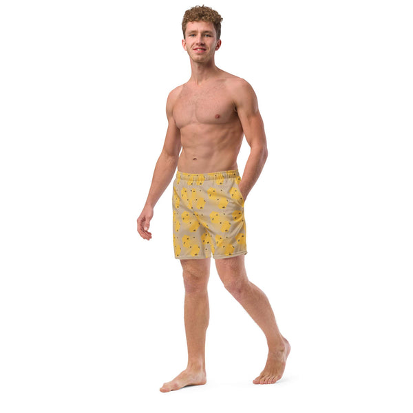 A left-side angle of the model showing the breathable fabric and mesh pockets on the honeycomb bee swim trunks.