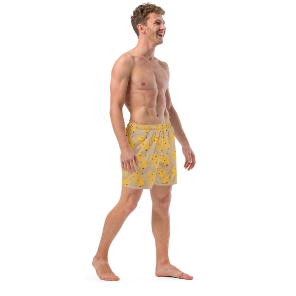 A right-side perspective of the model wearing the honeycomb bee swim trunks, emphasizing the comfortable drawcord fit.