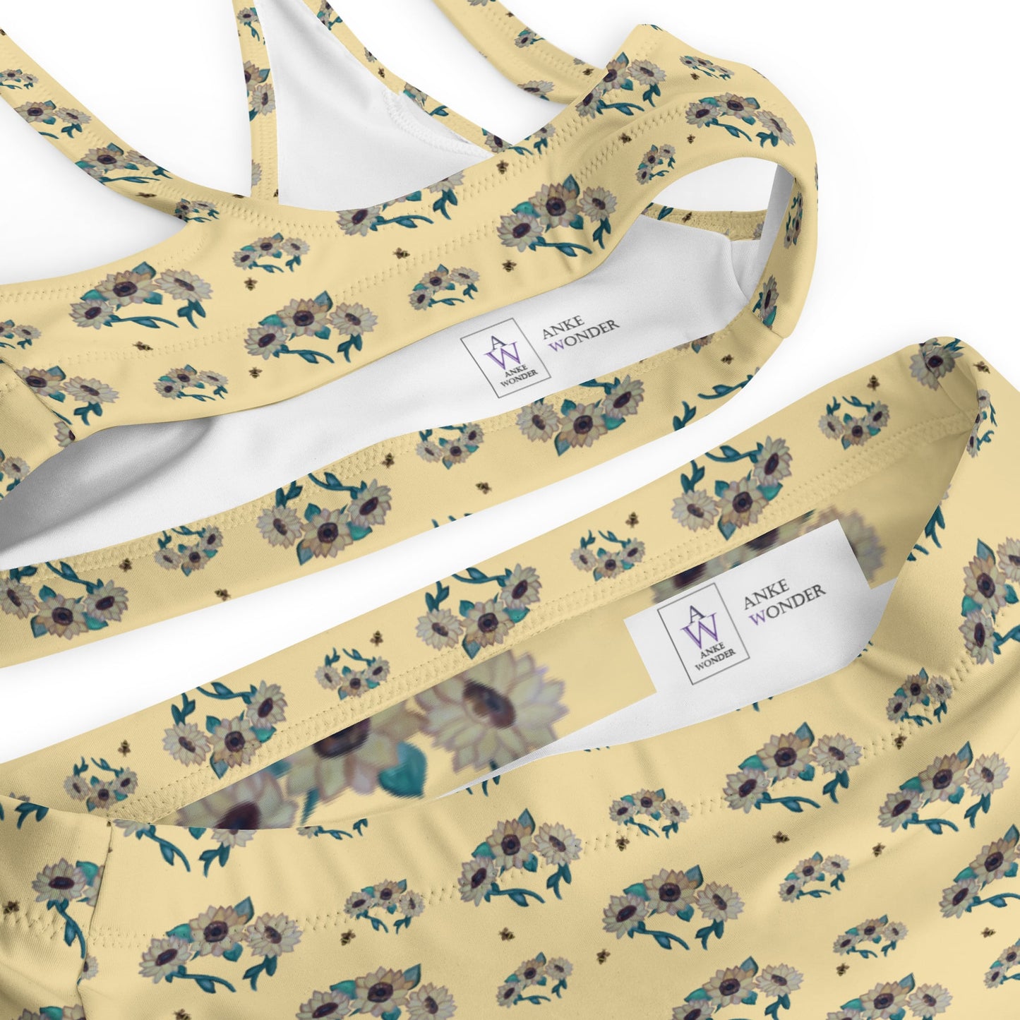 Inside of yellow floral patterned  bikini with Anke Wonder label on a white background