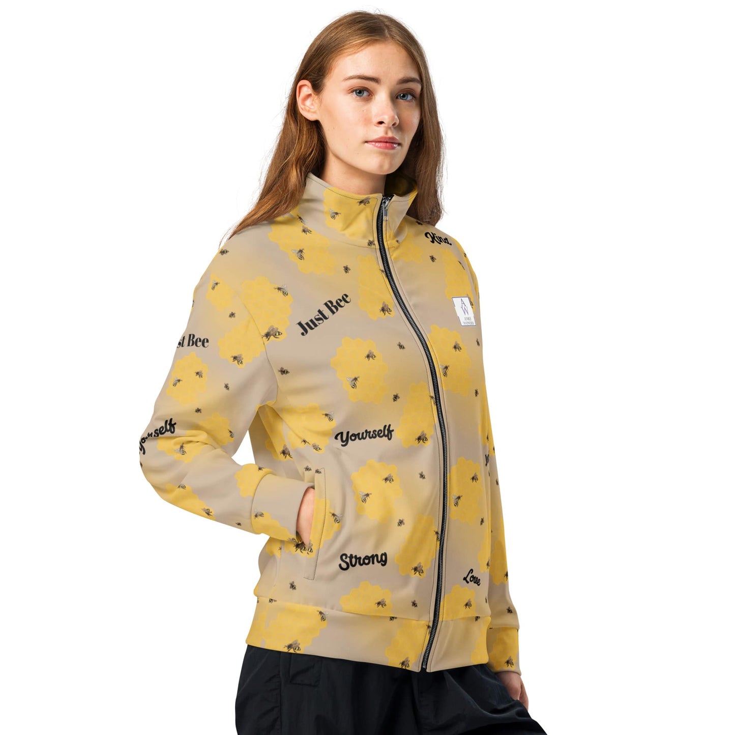 Side view of Women’s bee-themed track jacket with honeycomb and positive words like “Just Bee,” “Strong,” and “Yourself” on recycled polyester.