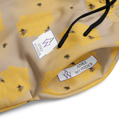 Side close-up of men's joggers showing bee artwork and eco-conscious Anke Wonder Branding.