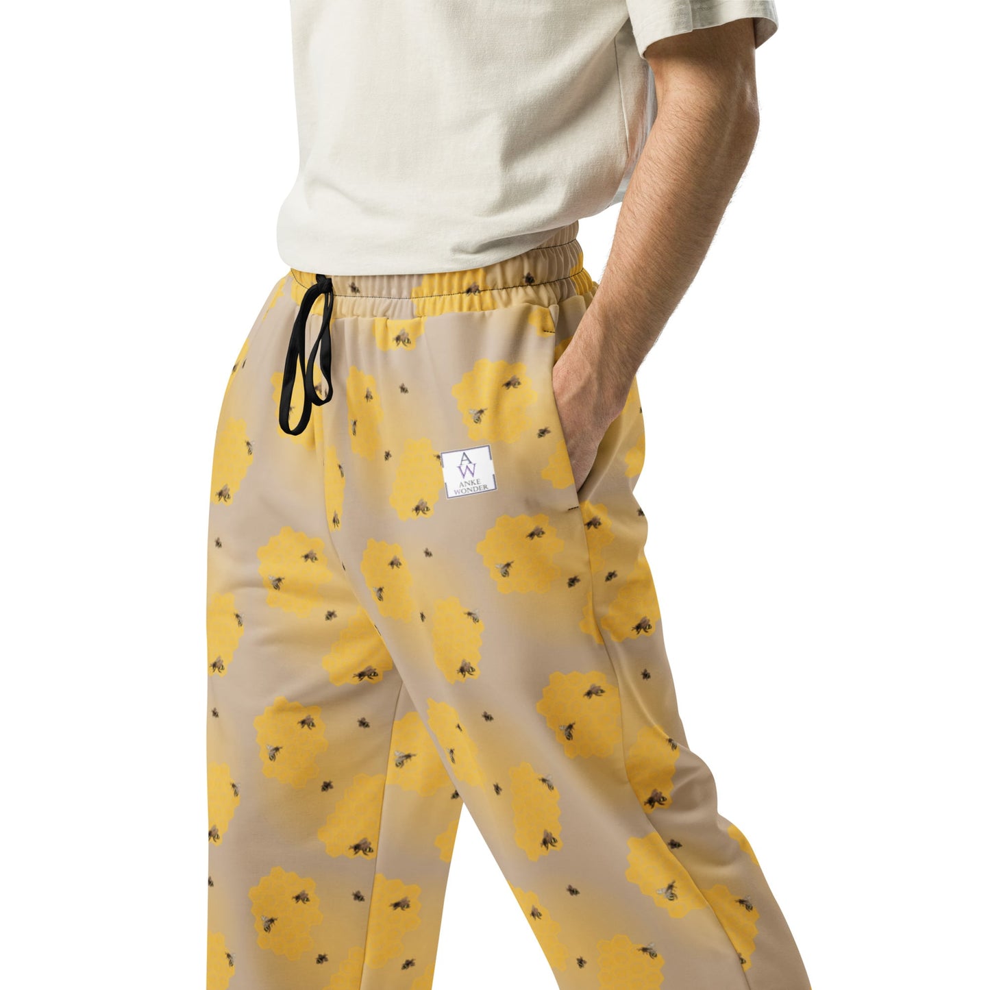 Close-up of mens joggers with yellow handpainted bee print, made from recycled materials and the Anke Wonder branding.