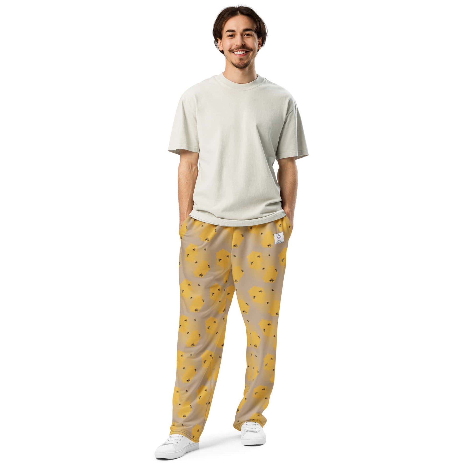 Front view of man wearing bee-themed joggers featuring yellow pattern from handpainted artwork.