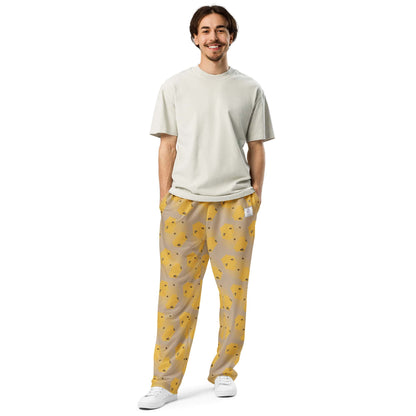 Front view of man wearing bee-themed joggers featuring yellow pattern from handpainted artwork.