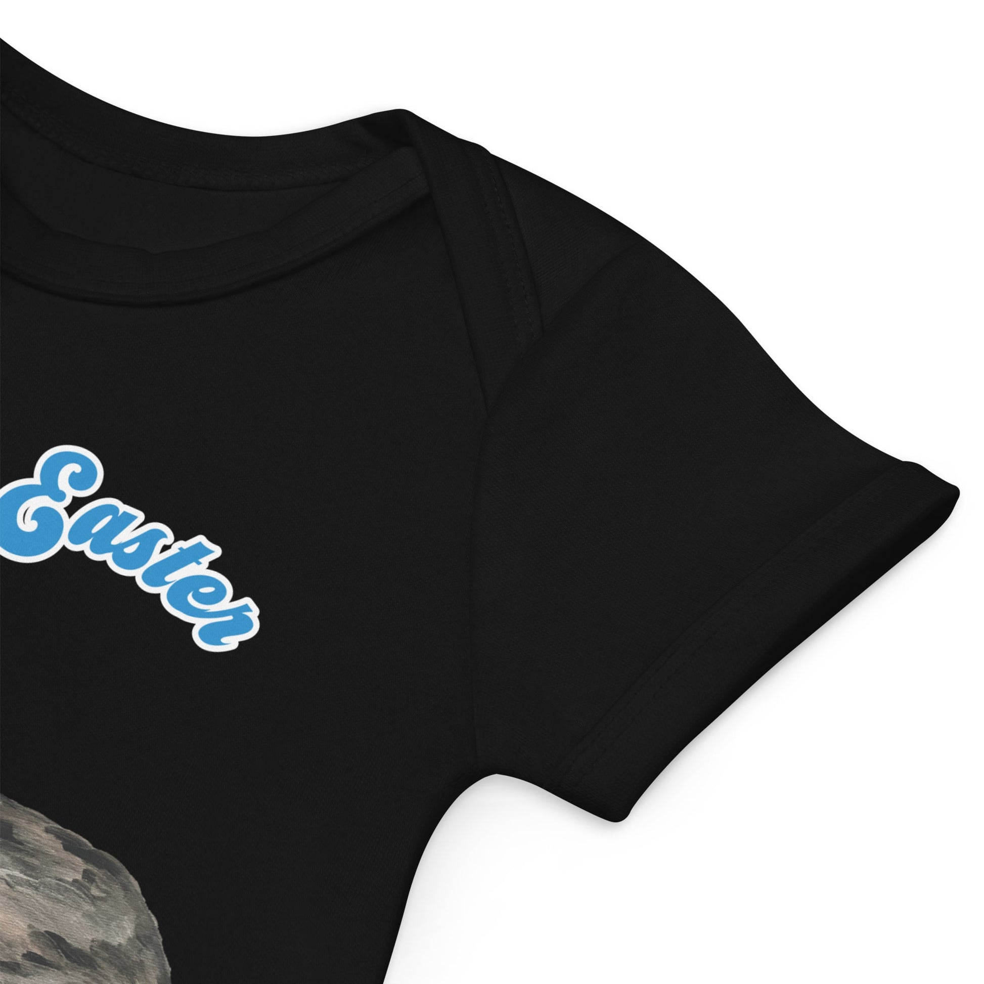 Close-up view of envelope sleeve of a black short-sleeve organic cotton baby bodysuit featuring a bunny and Easter basket design, with 'My First Easter' in blue text.