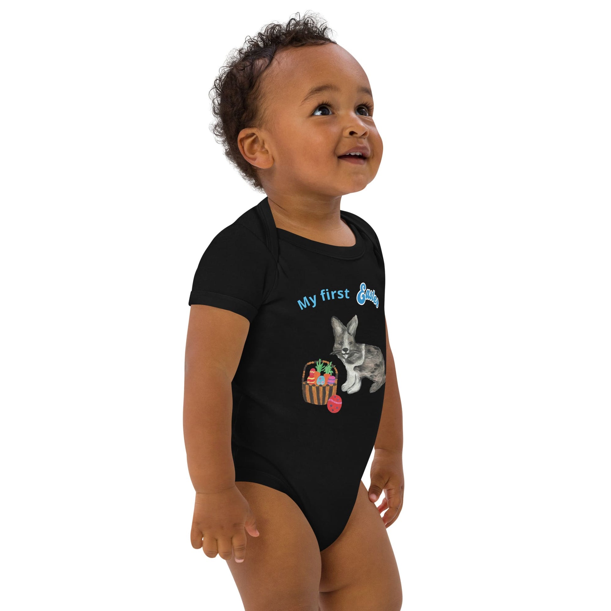 Front right view of a black short-sleeve organic cotton baby bodysuit featuring a bunny and Easter basket design, with 'My First Easter' in blue text.