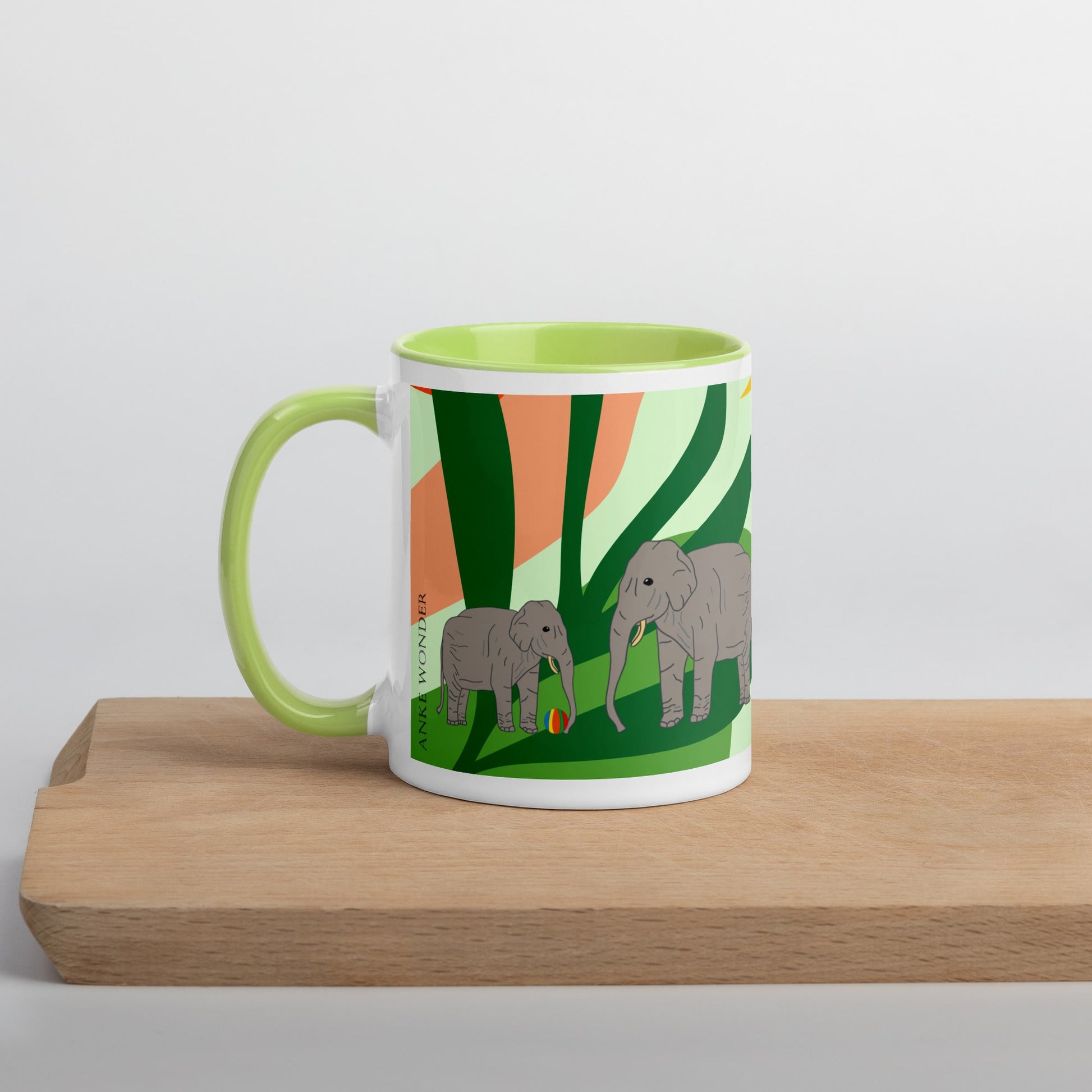 Left side of green-handled elephant mug showing a vibrant, abstract jungle setting with two grey elephants – illustrated by Anke Wonder.