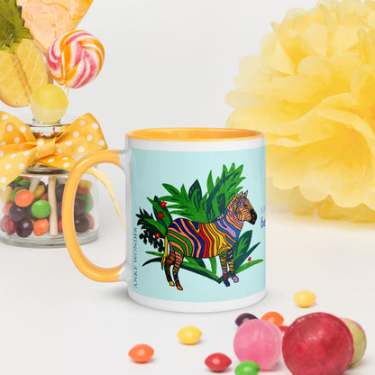 Mug with a colorful zebra design on a light blue background, surrounded by candies and flowers.