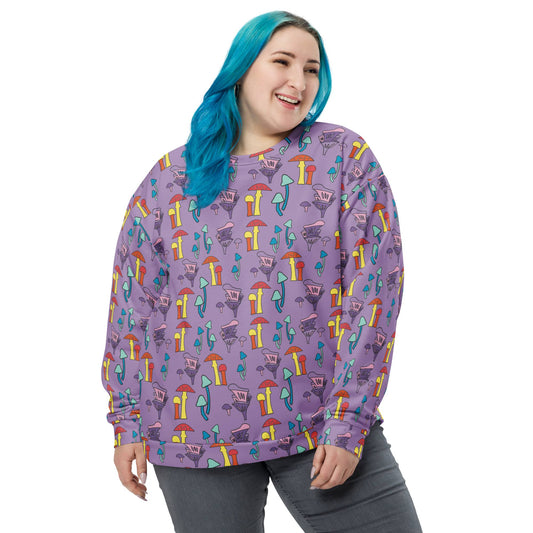 Smiling woman with blue hair wearing a purple sweatshirt featuring a colorful mushroom pattern. The sweatshirt has a relaxed fit with long sleeves and a soft, cozy appearance