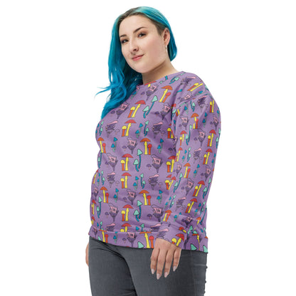 ide view of a woman with blue hair wearing a purple mushroom-print sweatshirt. The relaxed fit drapes comfortably, showing the sweatshirt’s long sleeves and soft fabric texture.