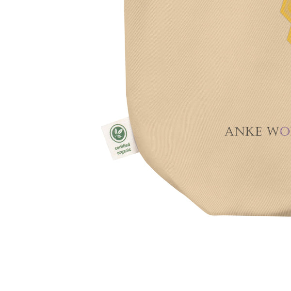 Close-up of black bees and honeycomb with the quote “Bee Yourself” printed on beige organic cotton fabric.