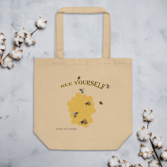 Organic tote bag featuring bees, honeycomb, and the uplifting message “Bee Yourself.”