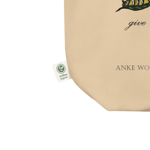 A detailed close-up of the certified organic cotton label stitched onto the tote bag, highlighting its eco-friendly material and sustainable production.