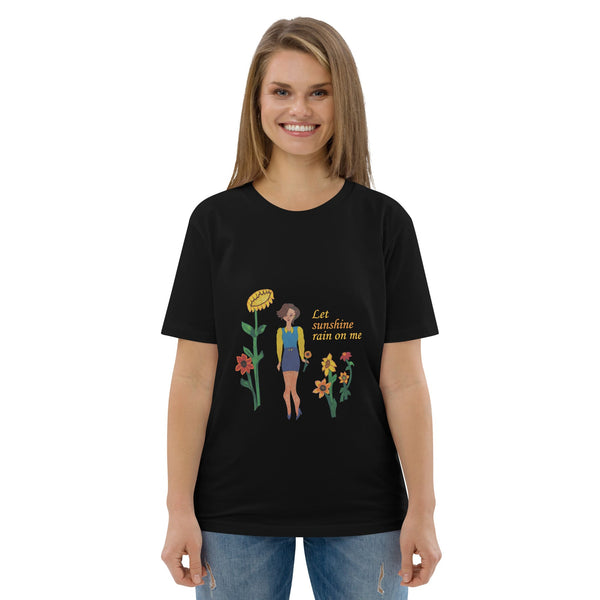 Woman wearing a black t-shirt with a colorful graphic and text 'Let sunshine rain on me'on a white background