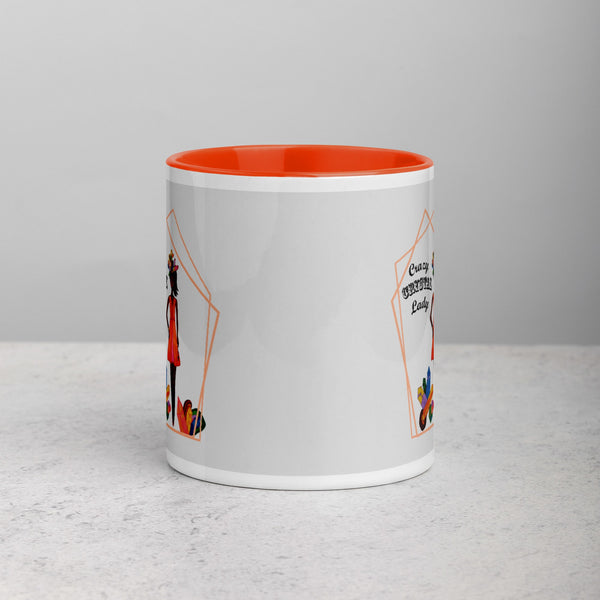 White mug with orange interior and graphic design on a gray background
