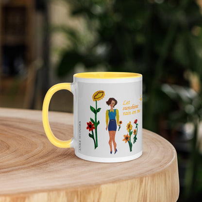 Mug with a colorful design of a woman and sunflowers on a wooden surface with a blurred green background