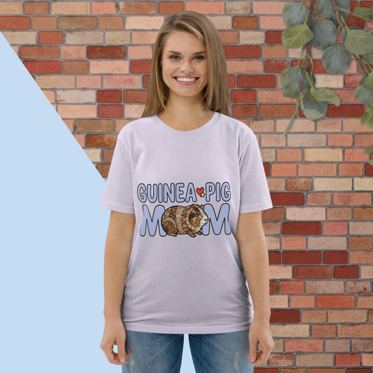 Woman wearing a 'Guinea Pig Mom' t-shirt in front of a brick wall.
