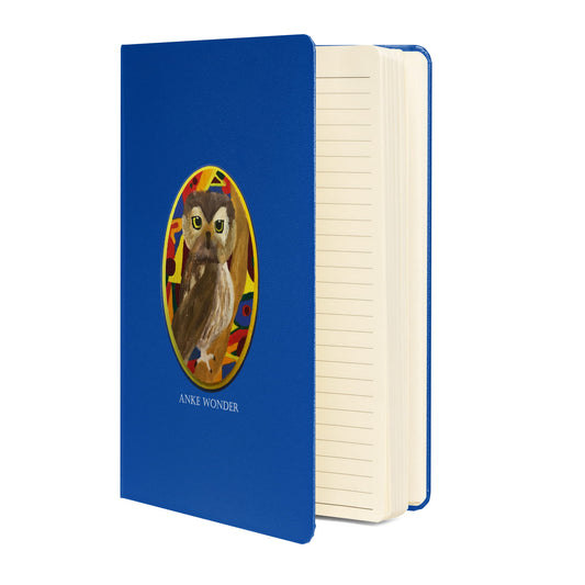 Blue hardcover journal with original colorful brown owl illustration in a decorative oval frame, designed by Anke Wonder.