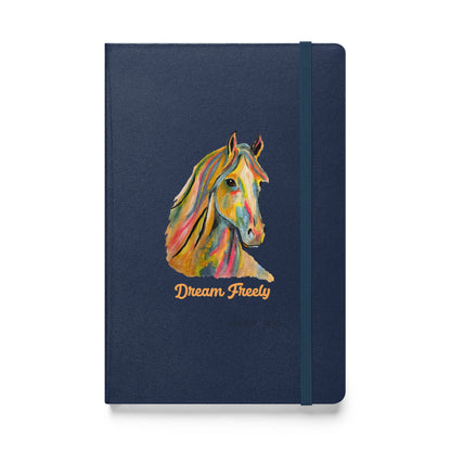 A navy blue hardcover notebook with an elastic closure band, featuring a colorful painted horse head illustration and the words 'Dream Freely' in gold on the front cover, shown against a plain white background.
